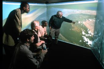 This three-screen virtual "immersion" environment at GTRI allowed researchers and scientists to study gorilla habitat remotely, 2000.