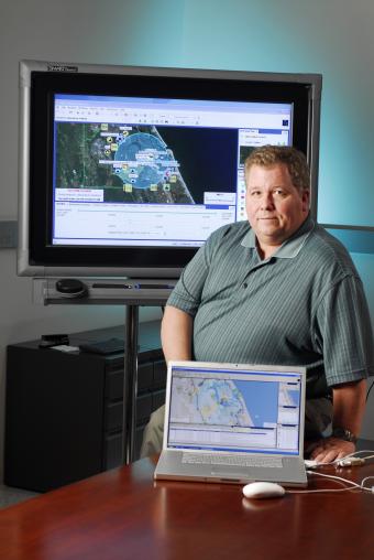 GTRI senior research engineer Kirk Pennywitt demonstrates GTVC, a mapping tool that allows emergency management personnel to visually track resources such as hospitals and water, 2007.