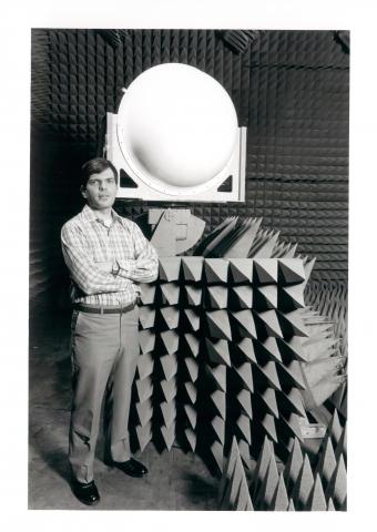 GTRI's Bill Cooke shows off an S-band telemetry antenna system used to collect data during MX missile testing programs, 1983.
