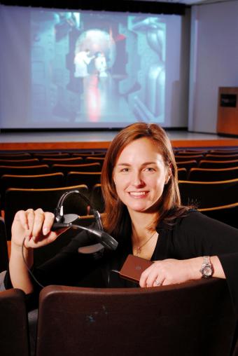 Leanne West, senior GTRI research scientist, demonstrates the wireless captioning system, 2007.