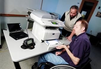 In the GTRI Accessibility Evaluation Facility, senior research scientist Brad Fain assesses a variety of products. Volunteer James Johnson, who uses a wheelchair for mobility, helps Fain, 2006