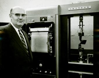 Researcher James L. Taylor and an Instron testing device, which measured the strength of yams and fibers and automatically plotted the data, 1958.