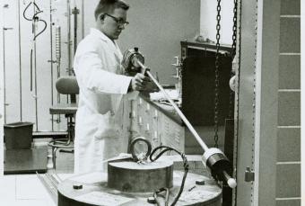 EES' Van Willis uses "Long Tom Cutie Pie" for a radiation survey around a 3750lb carrier in the Radioisotopes and Bioengineering Laboratory, 1960.